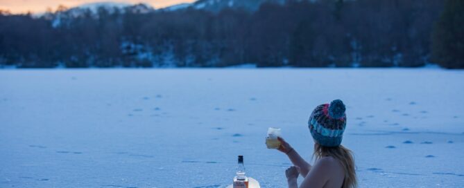 woman in black bikini top holding clear plastic bottle on water
