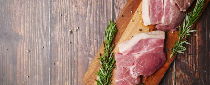 raw meat on brown wooden chopping board