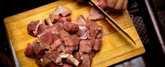 sliced meat on brown wooden chopping board