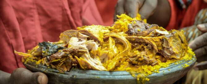 person holding a brown and yellow dish