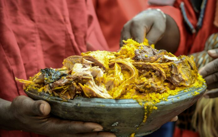 person holding a brown and yellow dish